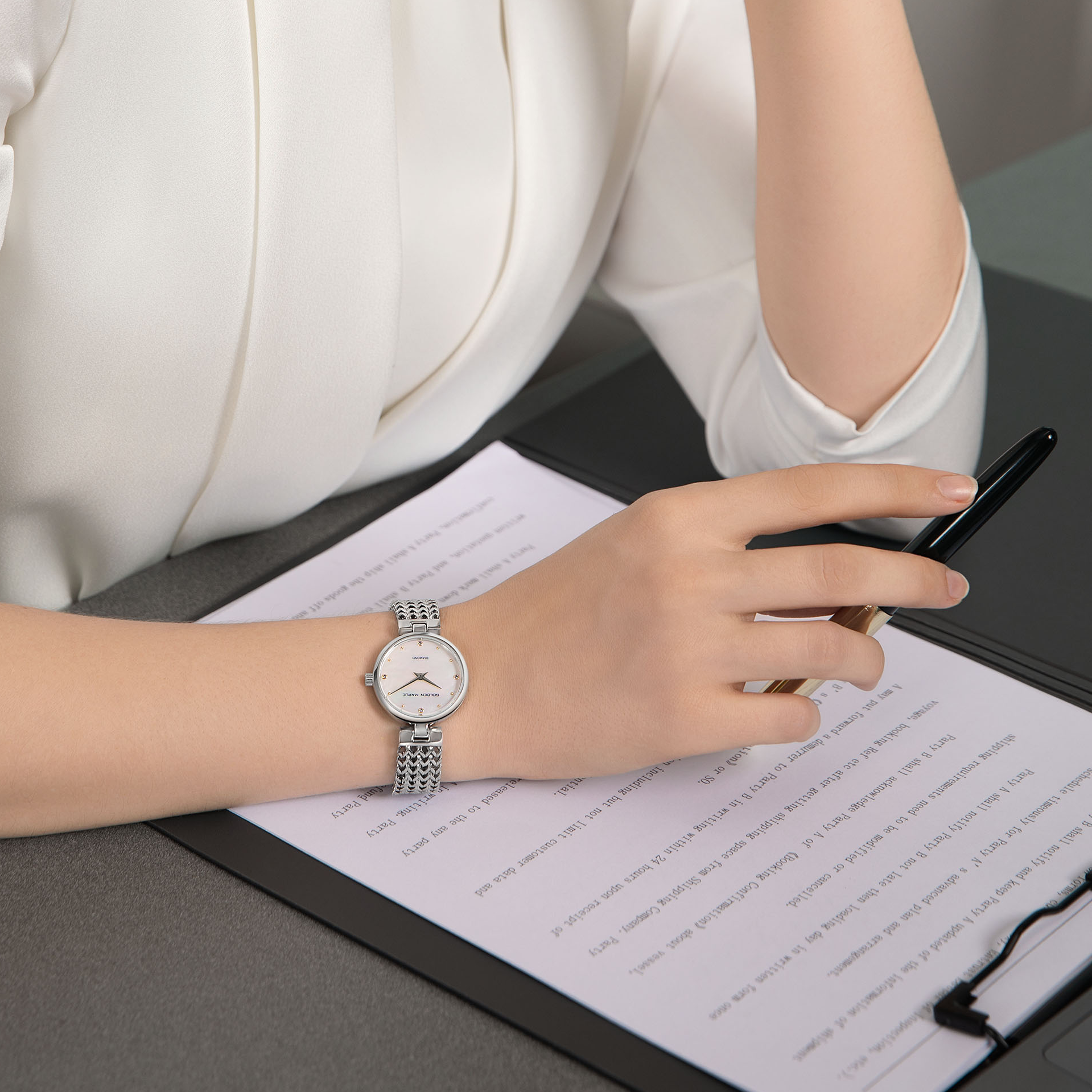 Woman wearing silver Astral watch on wrist - GOLDEN MAPLE elegant everyday style